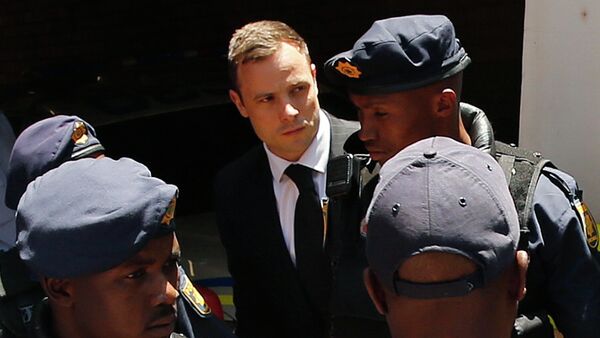 South African Olympic and Paralympic sprinter Oscar Pistorius (C) is escorted to a police van after his sentencing at the North Gauteng High Court in Pretoria October 21, 2014 - Sputnik International