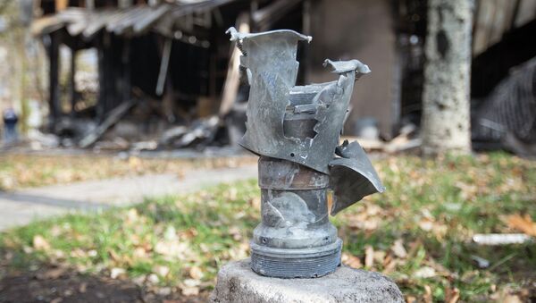 The remains of a projectile is seen in front of shops damaged by recent shellings in Donetsk, eastern Ukraine, October 21, 2014 - Sputnik International