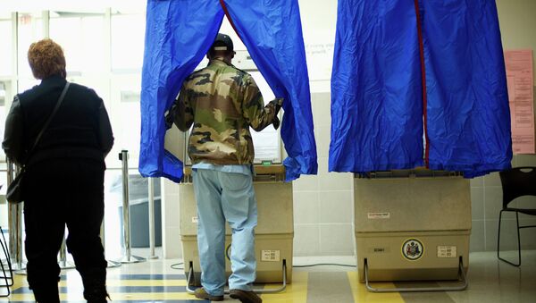 A man enters a voting booth at West Philadelphia High School on U.S. midterm election day morning in Philadelphia, Pennsylvania, November 4, 2014 - Sputnik International