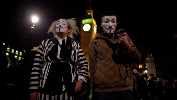 Anonymous supporters wearing Guy Fawkes masks take part in a protest outside Britain's Houses of Parliament in London - Sputnik International