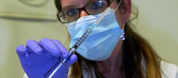 A nurse holds a syringe containing an experimental Ebola virus vaccine during a media visit at the Lausanne University Hospital (CHUV) in Lausanne November 4, 2014 A nurse holds a syringe containing an experimental Ebola virus vaccine during a media visit at the Lausanne University Hospital (CHUV) in Lausanne November 4, 2014 - Sputnik International