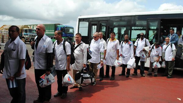 Cuban health workers arrive at Roberts Airport outside Monrovia, Liberia, October 22, 2014. Cuba has been praised by US media recently for its impressive response to Ebola. - Sputnik International