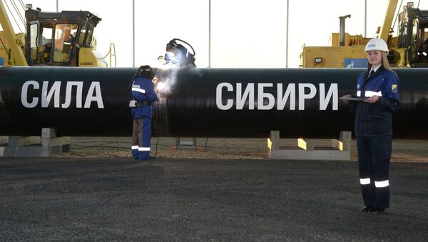 Above: Workers welding a seam to conneсt the first link of the Power of Siberia main gas pipeline. - Sputnik International