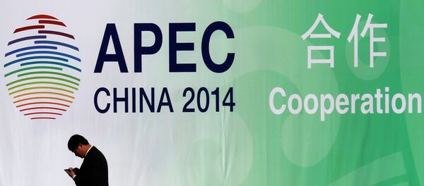 A man walks past a wall bearing a logo of the 2014 Asia Pacific Economic Cooperation (APEC) at the venue for APEC CEO Summit while its opening ceremony is being held in Beijing November 9, 2014. A man walks past a wall bearing a logo of the 2014 Asia Pacific Economic Cooperation (APEC) at the venue for APEC CEO Summit while its opening ceremony is being held in Beijing November 9, 2014. - Sputnik International
