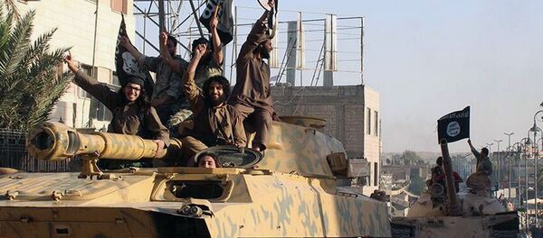 This undated image posted by the Raqqa Media Center, a Syrian opposition group, on Monday, June 30, 2014, which has been verified and is consistent with other AP reporting, shows fighters from the al-Qaida linked Islamic State of Iraq and the Levant (ISIL) during a parade in Raqqa, Syria. - Sputnik International
