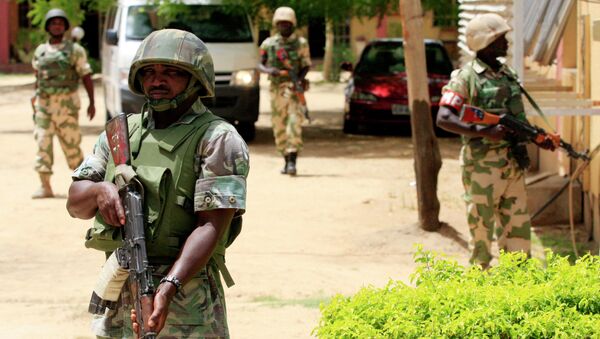 In this Thursday, June 6, 2013 file photo Nigerian soldiers stand guard at the offices of the state-run Nigerian Television Authority in Maiduguri, Nigeria - Sputnik International