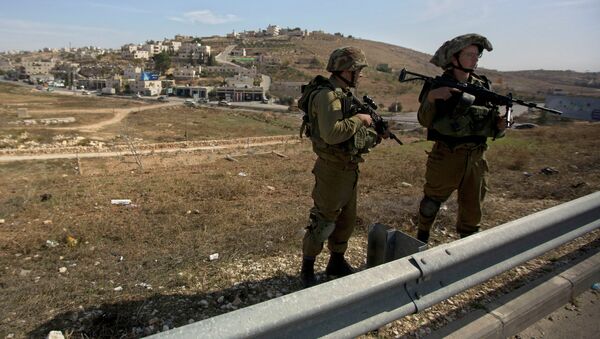 Israeli soldiers stand guard on the main road near the West bank village of Bet Sahour during the funeral of Dalia Lemkus, at the West Bank Jewish settlement of Tekoa, Tuesday, Nov. 11, 2014 - Sputnik International