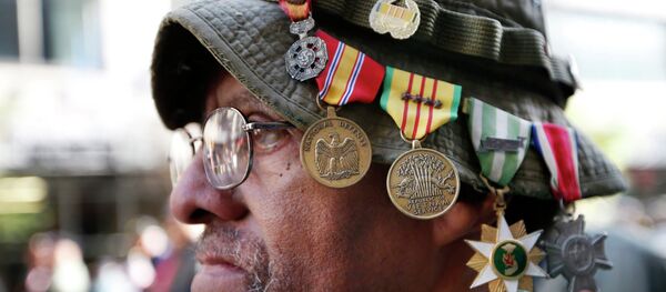 Vietnam veteran Laurence Lynch of Mount Vernon, NY, wears his medals on his hat as he marches with other Vietnam veterans during the annual Veterans Day parade in New York, Tuesday, Nov. 11, 2014 - Sputnik International