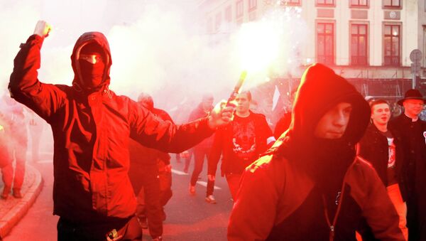 A far-right protester holds a flare during the annual far-right rally, which coincides with Poland's National Independence Day in Warsaw November 11, 2014 - Sputnik International