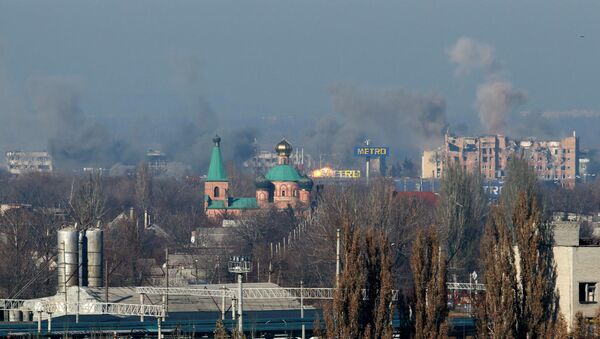 Smoke rises above an old terminal (L) and an administrative building of the Sergey Prokofiev International Airport after the recent shelling - Sputnik International