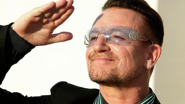 Bono, lead singer of the band U2, reacts after being awarded Commandeur des Arts et lettres (Commander in the Order of Arts and Letters) during a ceremony in Paris, in this file photo taken July 16, 2013 - Sputnik International