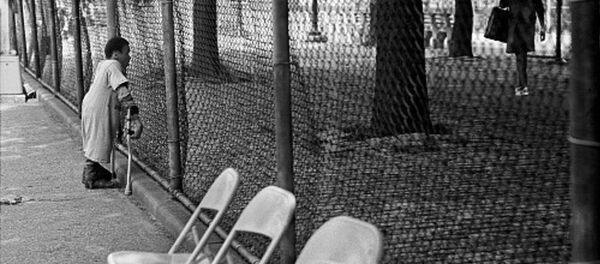 Boy on crutches watching a woman walk Boy on crutches watching a woman walk - Sputnik International