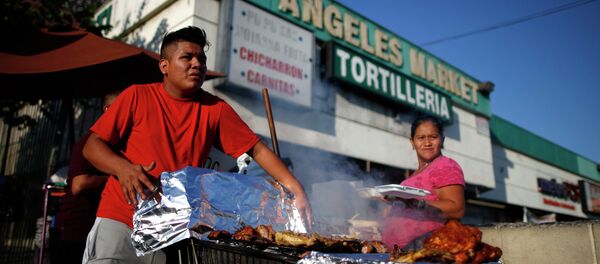 A man cooks meat in a shopping cart in the Westlake area of Los Angeles, home to many Mexican and Central American migrants, California A man cooks meat in a shopping cart in the Westlake area of Los Angeles, home to many Mexican and Central American migrants, California - Sputnik International