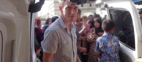 Abdul-Rahman (Peter) Kassig is pictured making a food delivery to refugees in Lebanon's Bekaa Valley in this May 2013 handout photo. Islamic State militants said in a video November 16, 2014 they had beheaded U.S. hostage aid worker Kassig and warned the United States they would kill other U.S. citizens. - Sputnik International