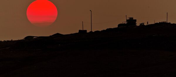 A soldier walks at a Turkish military outpost overlooking the Syrian city of Kobani on the Turkey-Syria border. - Sputnik International