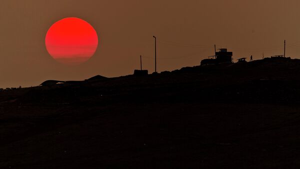 A soldier walks at a Turkish military outpost overlooking the Syrian city of Kobani on the Turkey-Syria border. - Sputnik International