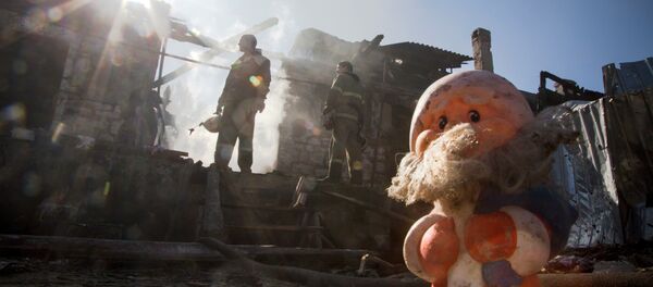Firefighters inspect a burned house after shelling in the town of Donetsk, eastern Ukraine, Firefighters inspect a burned house after shelling in the town of Donetsk, eastern Ukraine, - Sputnik International