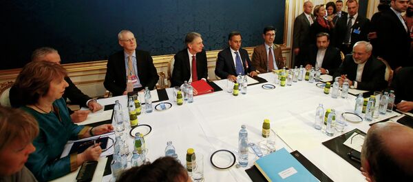 EU envoy Catherine Ashton (L), Britain's Foreign Secretary Philip Hammond (C) and Iranian Foreign Minister Javad Zarif sit at a table during talks in Vienna November 21, 2014 EU envoy Catherine Ashton (L), Britain's Foreign Secretary Philip Hammond (C) and Iranian Foreign Minister Javad Zarif sit at a table during talks in Vienna November 21, 2014 - Sputnik International