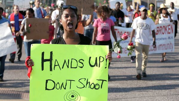 Protesters march Tuesday for Michael Brown, who was killed by police in Ferguson - Sputnik International