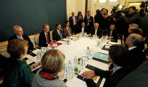 Former EU foreign policy chief Catherine Ashton, left, British Foreign Secretary Philip Hammond, third left, Iranian Foreign Minister Mohammad Javad Zarif, rear center, and French Foreign Minister Laurent Fabius, second right, wait for the start of closed-door nuclear talks with Iran. - Sputnik International