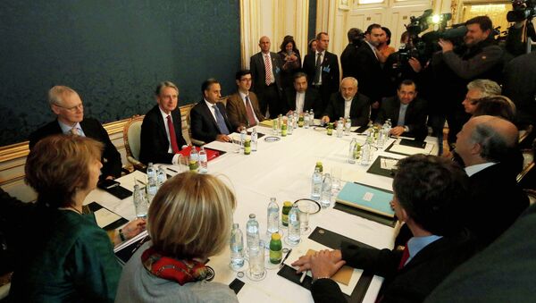 Former EU foreign policy chief Catherine Ashton, left, British Foreign Secretary Philip Hammond, third left, Iranian Foreign Minister Mohammad Javad Zarif, rear center, and French Foreign Minister Laurent Fabius, second right, wait for the start of closed-door nuclear talks with Iran. - Sputnik International