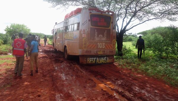 Rescue workers walk near a Nairobi-bound bus that was ambushed outside Mandera town, near Kenya's border with Somalia and Ethiopia, November 22, 2014 - Sputnik International