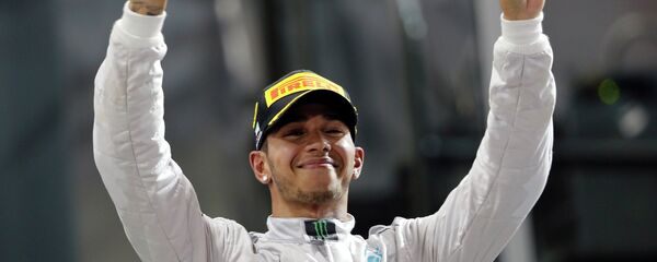 Mercedes Formula One driver Lewis Hamilton of Britain celebrates on the podium after winning the Abu Dhabi F1 Grand Prix at the Yas Marina circuit in Abu Dhabi - Sputnik International