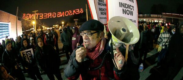 Protesters gather in front of the Ferguson Police Department before the announcement of the grand jury decision about whether to indict a Ferguson police officer in the shooting death of Michael Brown in Ferguson Protesters gather in front of the Ferguson Police Department before the announcement of the grand jury decision about whether to indict a Ferguson police officer in the shooting death of Michael Brown in Ferguson - Sputnik International