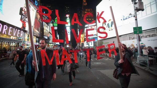Protesters demonstrate in Times Square after the grand jury's decision to not indite Ferguson police officer Darren Wilson in the shooting death of unarmed 18-year-old Michael Brown was announced, in New York - Sputnik International