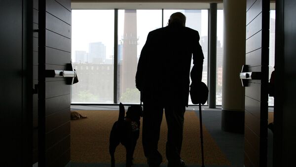 Wilson Hulley of Chevy Chase, Md., and his service dog Laurel leave at the end of the New England Assistance Dog Services (NEADS) graduation for dogs who assist the deaf and disabled at the Boston Convention and Exhibition Center - Sputnik International