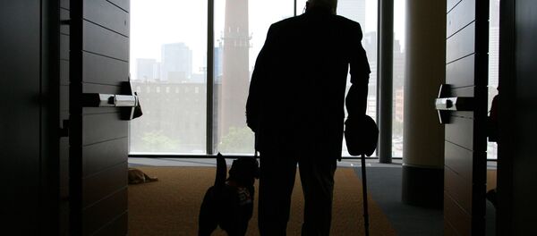 Wilson Hulley of Chevy Chase, Md., and his service dog Laurel leave at the end of the New England Assistance Dog Services (NEADS) graduation for dogs who assist the deaf and disabled at the Boston Convention and Exhibition Center - Sputnik International