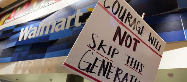 Demonstrators protest in a Walmart store located along the route of a Justice for Mike Brown march and rally after a grand jury failed to indict a white police officer in the shooting death of African-American teenager Michael Brown, in Washington November 25, 2014. Demonstrators protest in a Walmart store located along the route of a Justice for Mike Brown march and rally after a grand jury failed to indict a white police officer in the shooting death of African-American teenager Michael Brown, in Washington November 25, 2014. - Sputnik International
