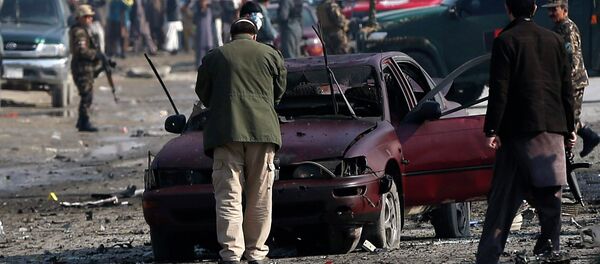 Afghan security forces inspect the site of a suicide attack on a British embassy vehicle in Kabul, November 27, 2014 - Sputnik International