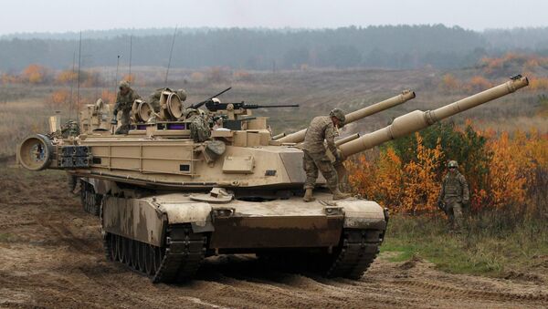 Members of the U.S. 1st Brigade Combat Team, 1st Cavalry Division disembark from an Abrams tank during a military exercise with Poland's 1st Mechanized Battalion of the 7th Coastal Defence Brigade near Drawsko-Pomorskie November 13, 2014 - Sputnik International