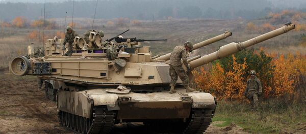 Members of the U.S. 1st Brigade Combat Team, 1st Cavalry Division disembark from an Abrams tank during a military exercise with Poland's 1st Mechanized Battalion of the 7th Coastal Defence Brigade near Drawsko-Pomorskie November 13, 2014 - Sputnik International