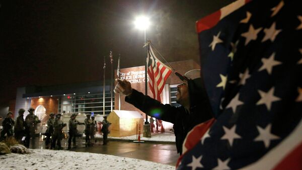 A protester shouts at the National Guard standing on duty outside the Ferguson Police Department after the grand jury verdict in the Michael Brown shooting in Ferguson, Missouri, November 26, 2014 - Sputnik International