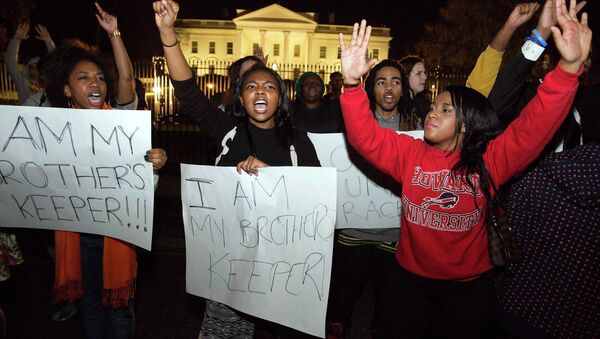 Protesters demonstrate after the decision by a Missouri grand jury not to indict a white Ferguson police officer in the fatal shooting of unarmed black teenager Michael Brown, in front of the White House in Washington - Sputnik International