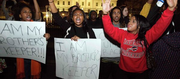 Protesters demonstrate after the decision by a Missouri grand jury not to indict a white Ferguson police officer in the fatal shooting of unarmed black teenager Michael Brown, in front of the White House in Washington - Sputnik International