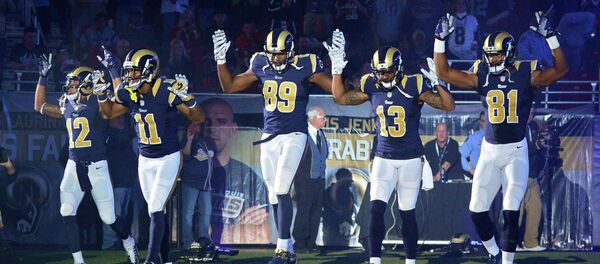 St. Louis Rams wide receiver Stedman Bailey (12), wide receiver Tavon Austin (11), tight end Jared Cook (89), wide receiver Chris Givens (13) and wide receiver Kenny Britt (81) put their hands up to show support for Michael Brown before a game against the Oakland Raiders at the Edward Jones Dome in St Louis November 30, 2014. St. Louis Rams wide receiver Stedman Bailey (12), wide receiver Tavon Austin (11), tight end Jared Cook (89), wide receiver Chris Givens (13) and wide receiver Kenny Britt (81) put their hands up to show support for Michael Brown before a game against the Oakland Raiders at the Edward Jones Dome in St Louis November 30, 2014. - Sputnik International