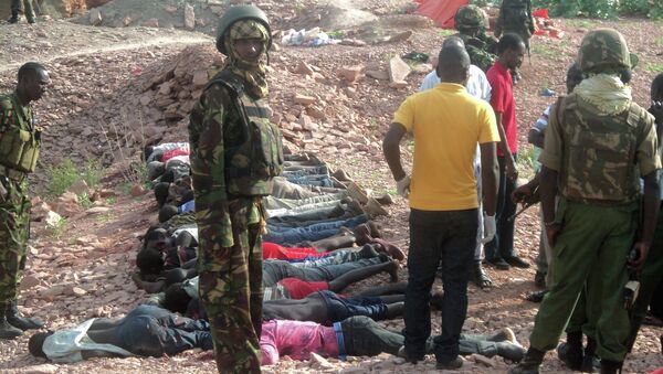 Kenyan military personnel stand near bodies lined up on the ground at a quarry site where attackers killed at least 36 workers in a village in Korome, outside the border town of Mandera December 2, 2014 - Sputnik International