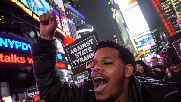 A protester, demanding justice for the death of Eric Garner, shouts slogans while marching through Times Square, in the Manhattan borough of New York - Sputnik International