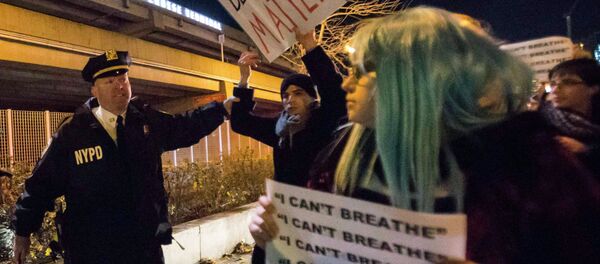 A policeman grabs a protester, who was demanding justice for the death of Eric Garner, as he was marching along the West Side Highway in Manhattan, New York December 3, 2014. - Sputnik International