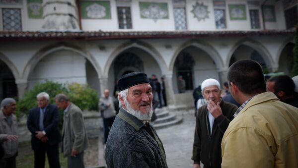 Crimean Tatars speak to each other after the prayer in a mosque marking the Eid al-Adha, celebrated by Muslims worldwide, in Bakhchisarai, Crimea - Sputnik International