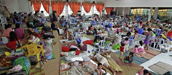 People take shelter inside a evacuation centre after evacuating from their homes due to super-typhoon Hagupit in Surigao city, southern Philippines December 5, 2014 People take shelter inside a evacuation centre after evacuating from their homes due to super-typhoon Hagupit in Surigao city, southern Philippines December 5, 2014 - Sputnik International