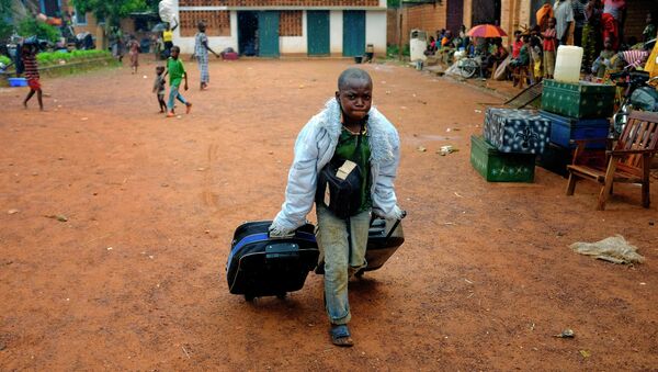 A young christian refugee carries his bags in the main church of Bambari, Central African Republic - Sputnik International