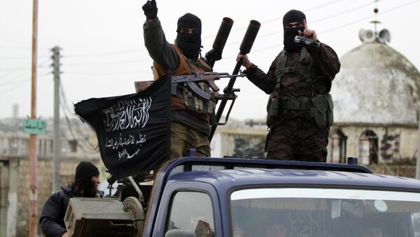 Members of al Qaeda's Nusra Front gesture as they drive in a convoy touring villages, which they said they have seized control of from Syrian rebel factions, in the southern countryside of Idlib, December 2, 2014 - Sputnik International