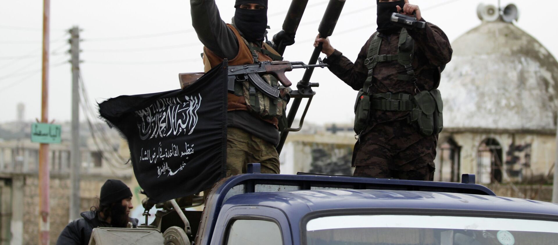 Members of al Qaeda's Nusra Front gesture as they drive in a convoy touring villages, which they said they have seized control of from Syrian rebel factions, in the southern countryside of Idlib, December 2, 2014 - Sputnik International, 1920, 30.04.2021