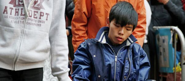 Student leader Joshua Wong attends a news conference as he sits on a wheel chair - Sputnik International