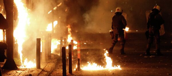 Riot police try to avoid petrol bombs thrown by protesters during clashes in the Athens neighborhood of Exarchia, a haven for extreme leftists and anarchists, on Saturday, Dec. 6, 2014 Riot police try to avoid petrol bombs thrown by protesters during clashes in the Athens neighborhood of Exarchia, a haven for extreme leftists and anarchists, on Saturday, Dec. 6, 2014 - Sputnik International
