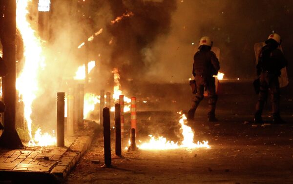 Riot police try to avoid petrol bombs thrown by protesters during clashes in the Athens neighborhood of Exarchia, a haven for extreme leftists and anarchists, on Saturday, Dec. 6, 2014 - Sputnik International